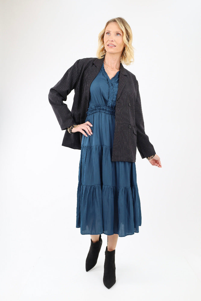 Blue ruffle midi dress with black coat and black boots