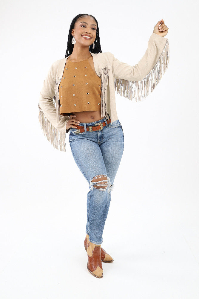 Brown boho crop top paired with a fringe jacket and jeans