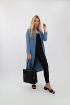 Denim shirtdress outfit with black purse, shoes, and jumpsuit