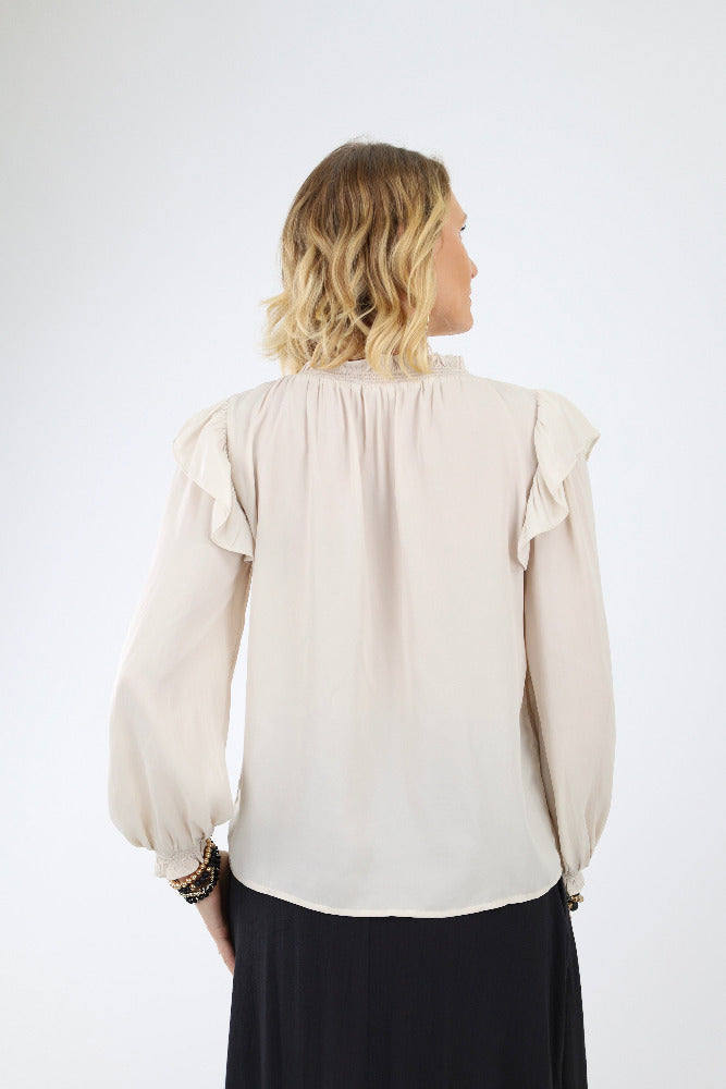 Back of cream smocked blouse