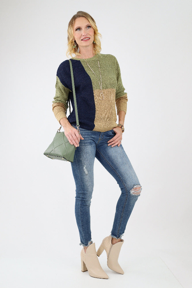 Colorblock Knit Pullover with an olive handbag, jeans, and off white boots