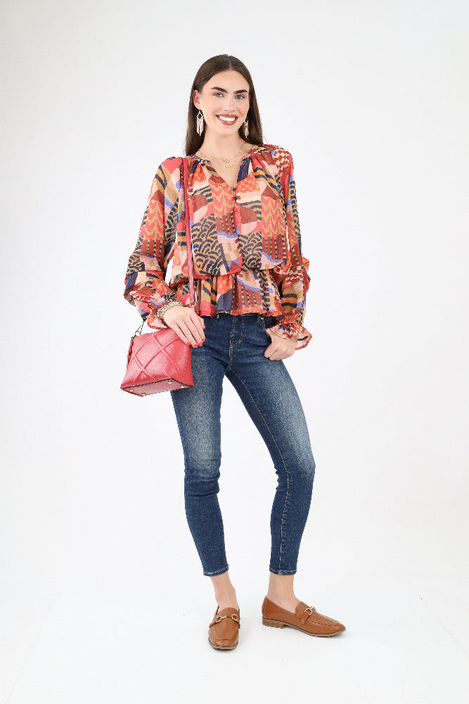 Multi colored abstract blouse with jeans and brown loafers