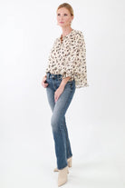 Gold hoop earrings, with a leopard print blouse, and jeans