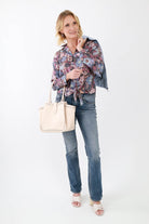 Silver hoops with a blue tie blouse, jeans, sandals, and cream tote bag