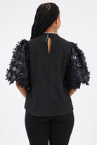 Back of Black Puff Sleeve Textured Top